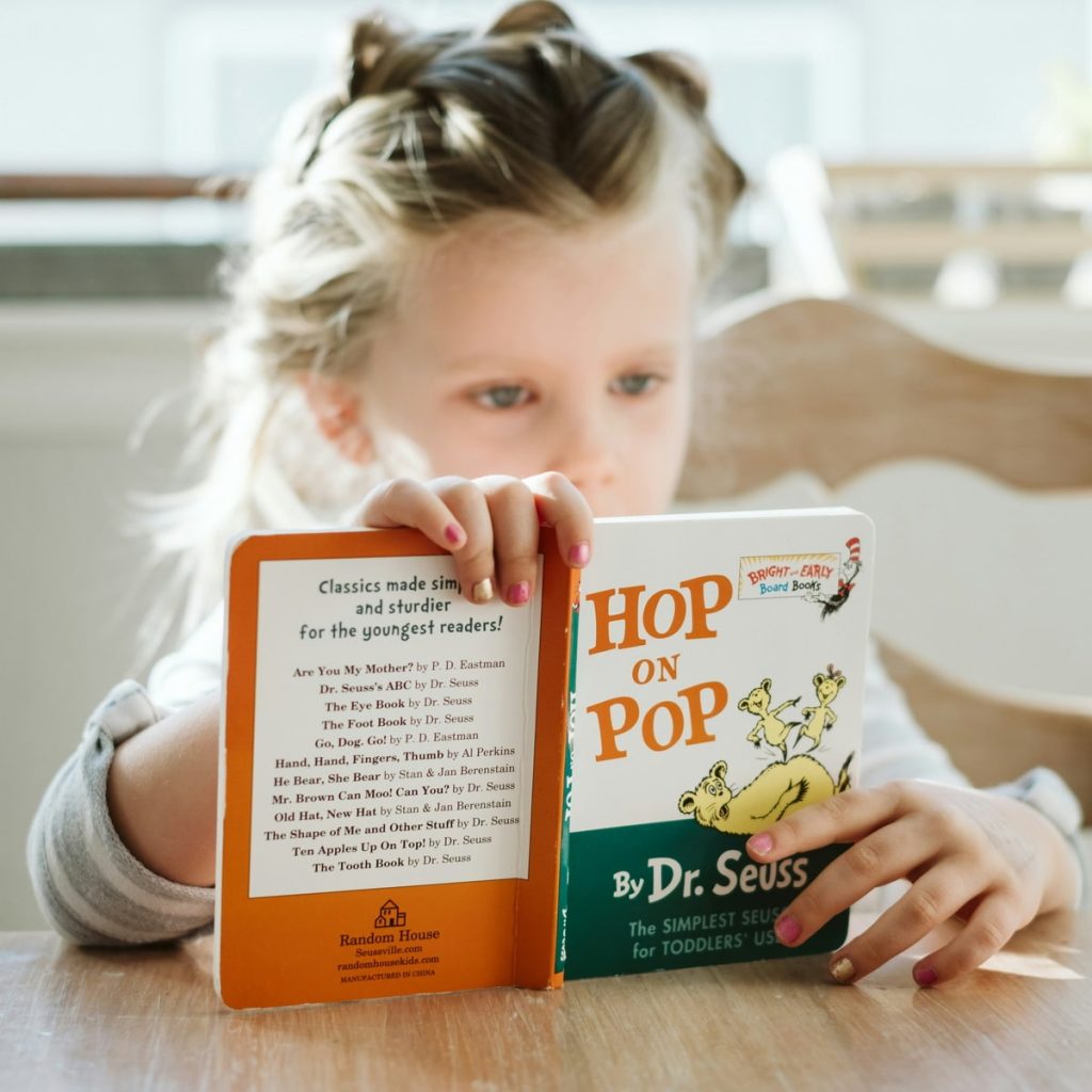A young girl reading a book